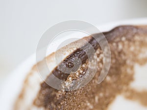 Coffee froth and coffee stain on white cup, close up