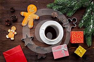 Coffee with gingebread cookies and gifts in christmas evening. Dark wooden background top view