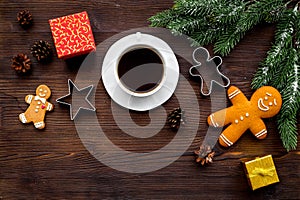 Coffee with gingebread cookies and gifts in christmas evening. Dark wooden background top view copyspace