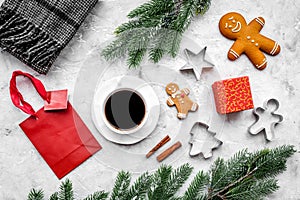 Coffee with gingebread cookies and gifts in christmas evening. Grey stone background top view