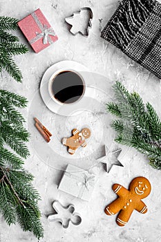 Coffee with gingebread cookies and gifts in christmas evening. Grey stone background top view