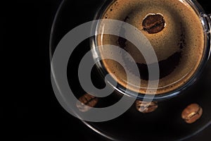 Coffee glass cup and coffee beans on saucer