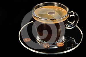 Coffee glass cup and coffee beans on saucer