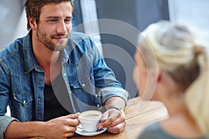 Coffee and good company. Over the shoulder shot of a handsome young man on a coffee date with his girlfriend.