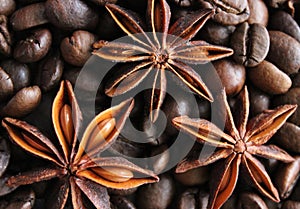 coffee grains and star anise on a wooden table, brown abstract background, warm texture, macro