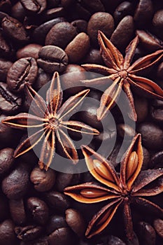 coffee grains and star anise on a wooden table, brown abstract background, warm texture, macro