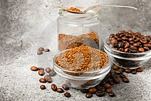 Coffee granules and coffee beans on background.