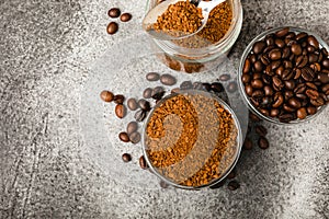 Coffee granules and coffee beans on background.