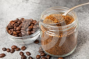 Coffee granules and coffee beans on background.