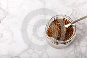 Coffee granules and coffee beans on background.