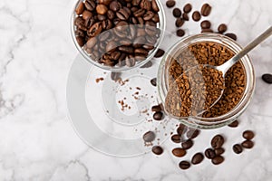 Coffee granules and coffee beans on background.