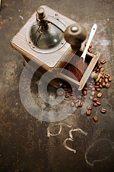Coffee grinder with beans and ground coffee