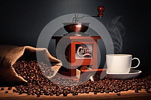 Coffee grinder with coffee bag and cup and coffee beans
