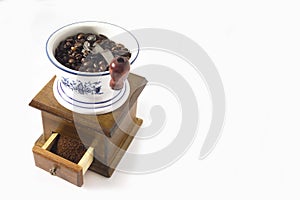 Coffee grinder with coffee beans. White background. Copy space for the text.