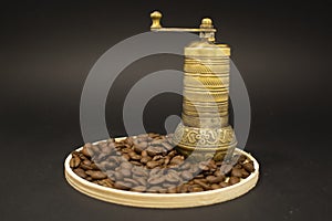 Coffee grinder with coffee beans on wooden table