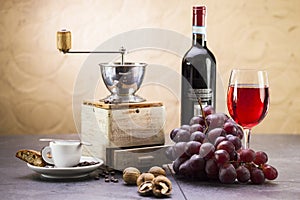 Coffee grinder, coffee and sweet Italian cookie cantuccini, grapes and glass of wine