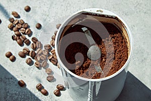 Coffee grinder with crushed coffee in sunlight