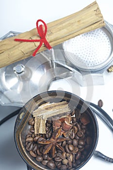 Coffee grinders, anise and cinnamon with other spices are covered in the coffee grinder. Next to it is a geyser coffee machine, di