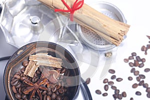 Coffee grinders, anise and cinnamon with other spices are covered in the coffee grinder. Next to it is a geyser coffee machine, di