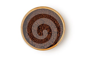 Coffee ground in wooden bowl on white background