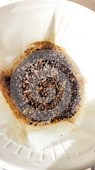 Coffee grounds that are in the process of brewing on filter paper