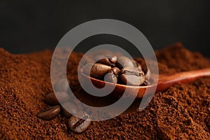 Coffee grounds and roasted beans on dark background, closeup