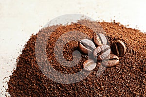 Coffee grounds and roasted beans on table