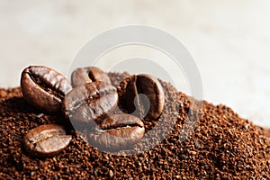 Coffee grounds and roasted beans on table