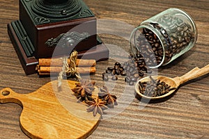 Coffee hand mill and spices on wooden table