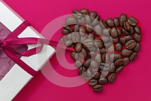 Coffee heart, roasted coffee beans and chocolate. Concept of Valentine`s Day, good mood, Endorphins, greeting cards