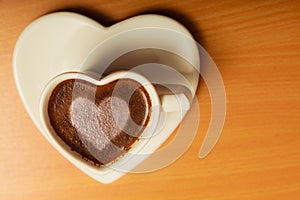 Coffee in heart shaped cup with love sign