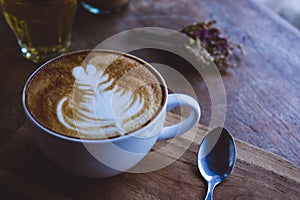 Coffee hot drink cappucino latte art on wood vintage table , cof