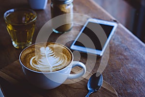 coffee hot drink cappucino latte art on wood vintage table , coffee time on wood background cafe