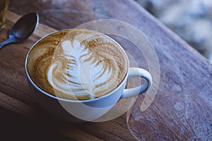 coffee hot drink cappucino latte art on wood vintage table , coffee time on wood background cafe