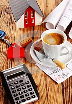 Coffee, House, Blueprint and Calculator on a Table photo