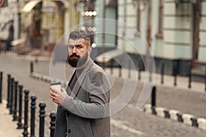 Coffee is a hug in a mug. Businessman in hipster style holding takeaway coffee. Drinking his cup first thing in morning