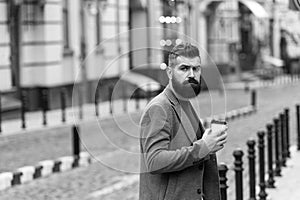 Coffee is a hug in a mug. Businessman in hipster style holding takeaway coffee. Drinking his cup first thing in morning