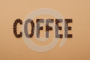 Coffee, the inscription is lined with coffee beans on background
