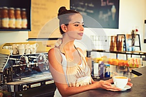 The coffee that inspires. Barista serve cup of hot coffee drink with smile. Brewing coffee in coffeehouse. Woman barista