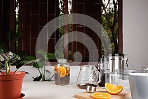 Coffee jar with fresh orange juice and coffee mixed together is iced americano orange juice coffee on the table with percolator