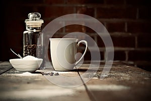Coffee jar on table next to sugar