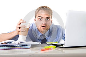 Coffee junkie businessman holding take away cup looking with crazy eyes and funny face expression overworked