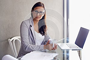 Coffee, laptop and portrait of business woman in office with confident and pride attitude. Technology, serious and