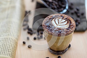 Coffee Latte Art. The coffee arts. Hot coffee in a white cup on wooden table. Hot chocolate Nutella latte art on wood table.