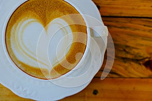 Coffee latte art on wood table cup