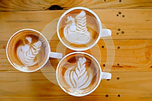 Coffee latte art on wood table tree