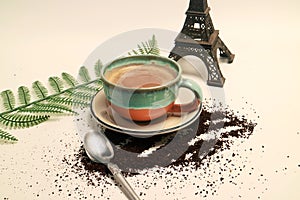 Coffee latte cappuccino in a cup with eiffel tower miniature french limbo background