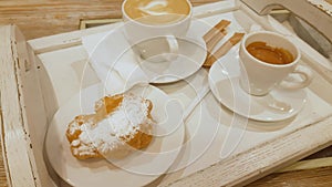 Coffee latte and coffee espresso in cups on wooden tray