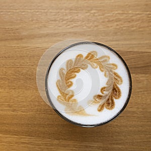 Coffee Latte In Glass Cup On Brown Table In Cafe