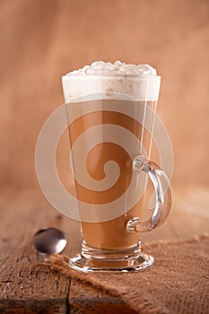 Coffee latte macchiato with cream in glass photo